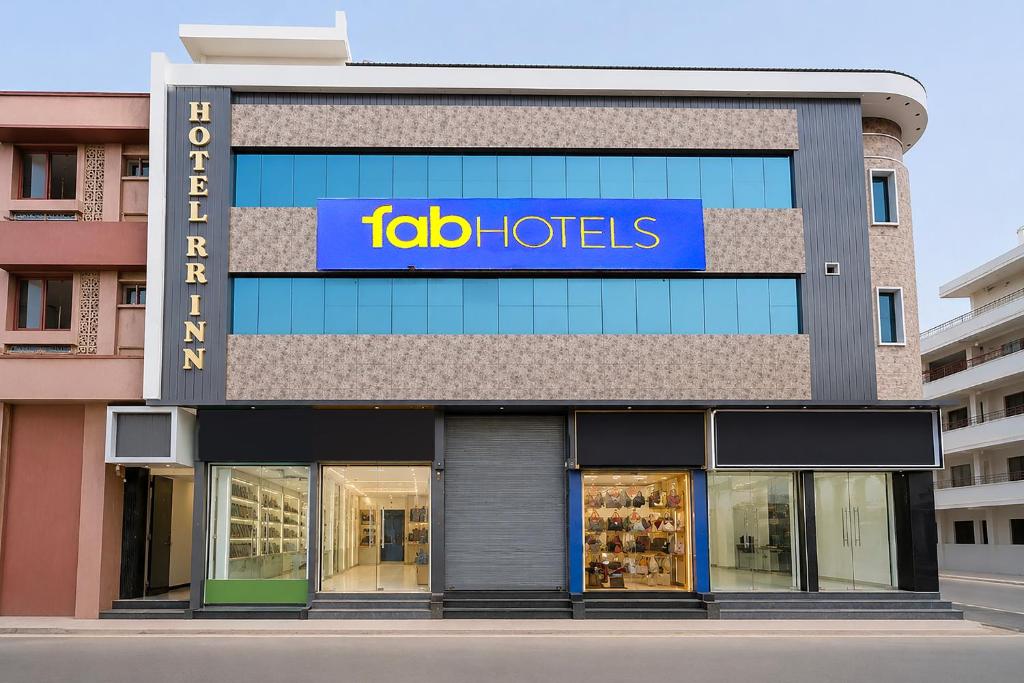 a store front with a blue sign on it at FabHotel RR Inn in Kānpur