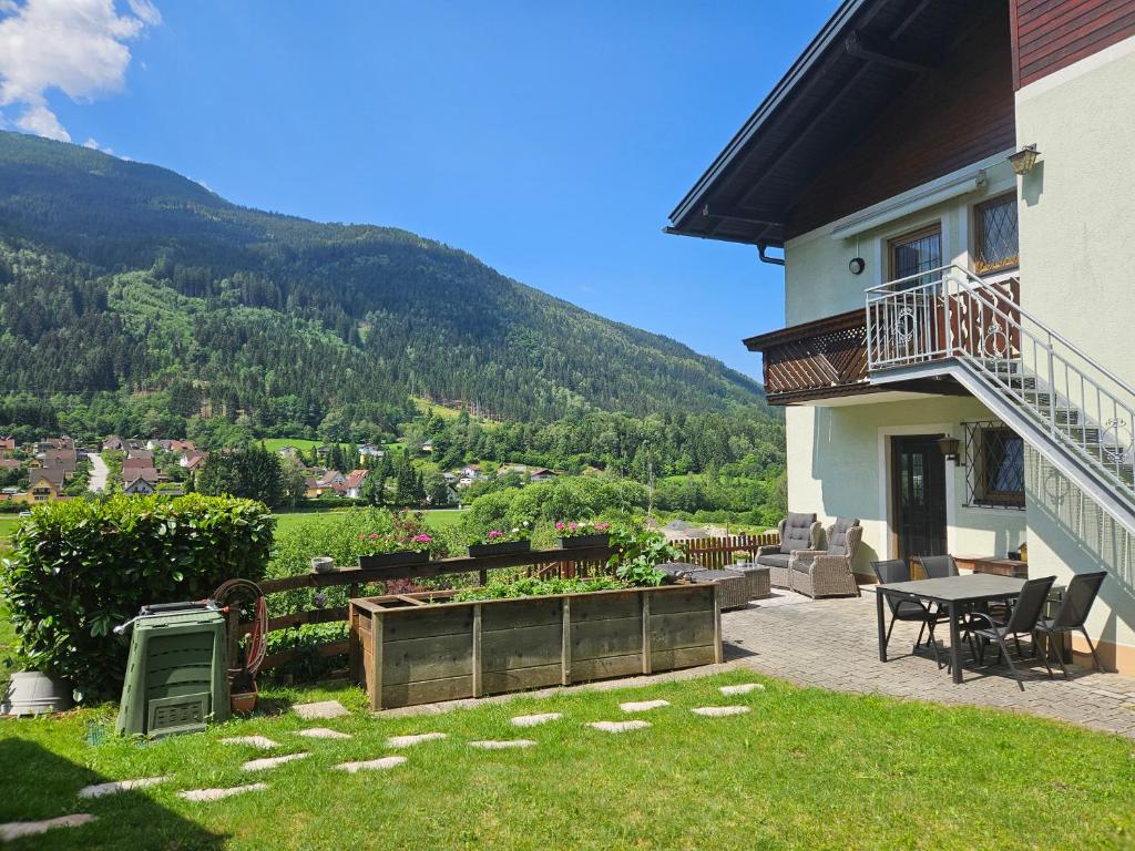 a house with a patio with a table and chairs at Mirnockblick Apartments in Radenthein