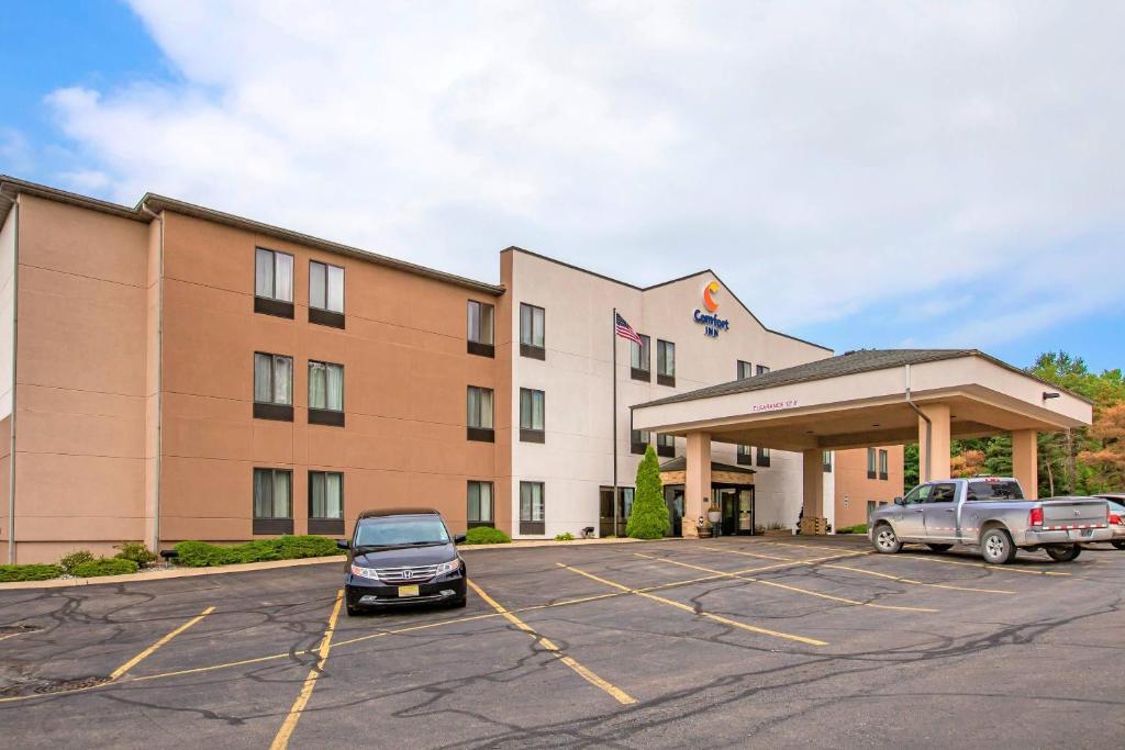 a hotel with cars parked in a parking lot at Comfort Inn Charlotte in Charlotte