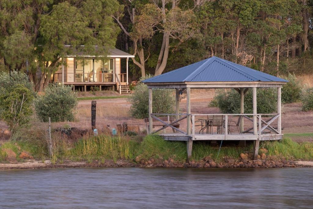 a house with a gazebo next to the water at Lake View Cottage in Metricup