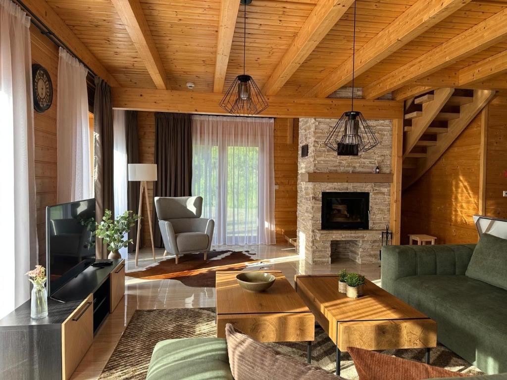 a living room with a couch and a fireplace at Chata Mila in Veľká Lomnica