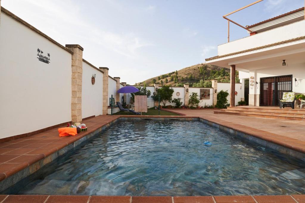 a swimming pool in the backyard of a house at La Majailla in Peal de Becerro