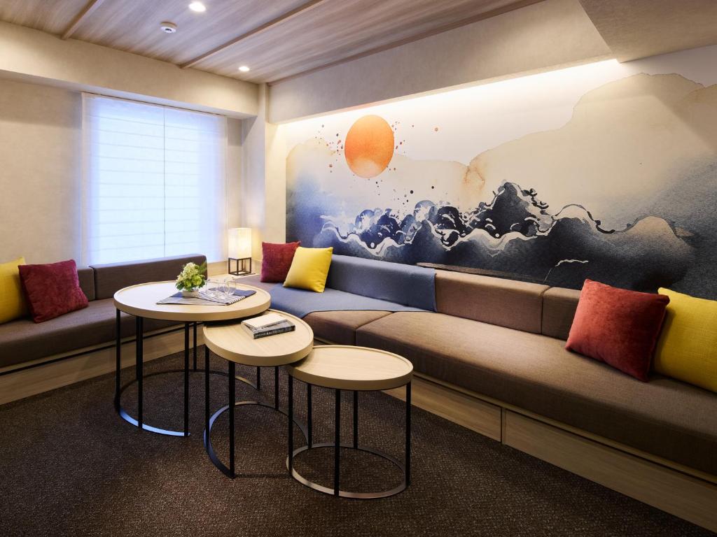 a living room with a couch and two tables at Minn Namba Nipponbashi in Osaka