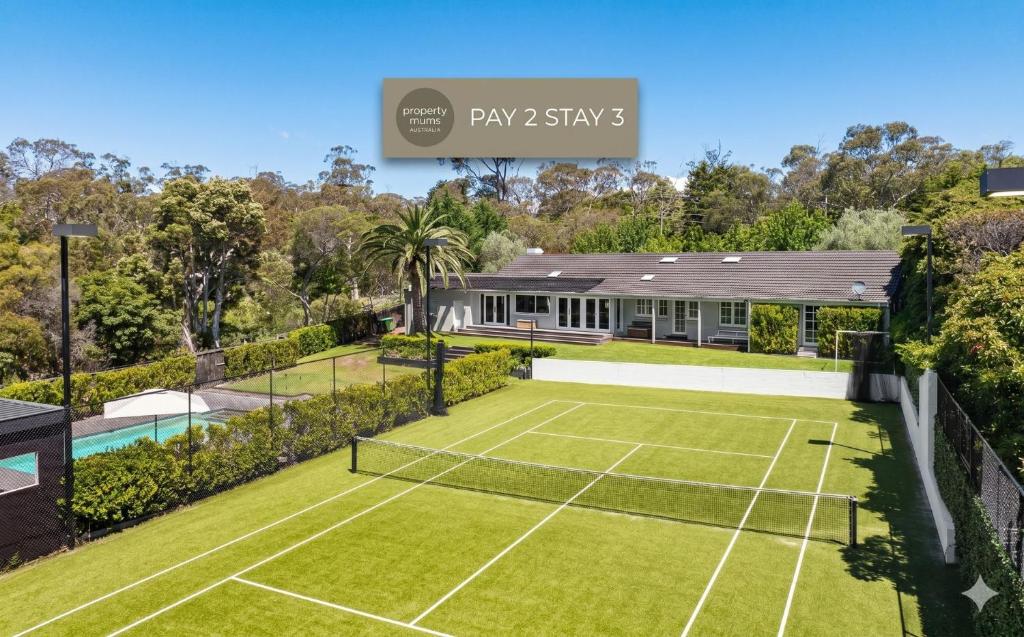 an image of a tennis court in a house at Whispering Woodlands with Pool and Tennis Court in Mount Eliza