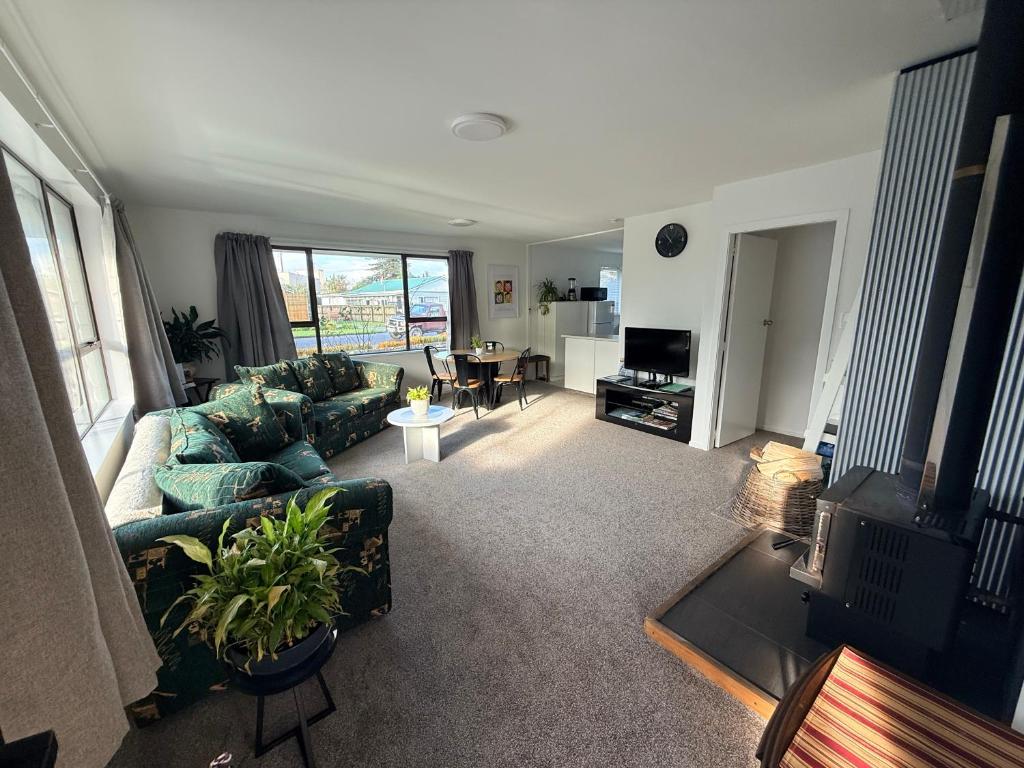 a living room with a couch and a table at B&B on Hoffman in Hokitika