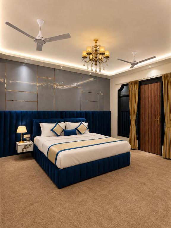 a bedroom with a large bed and a ceiling fan at Lucknow Courtyard in Lucknow