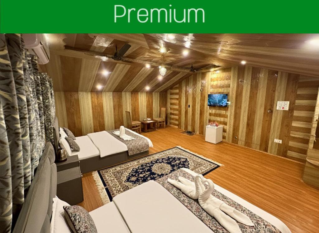 a room with two beds and a living room at Faizzy residency in Srinagar