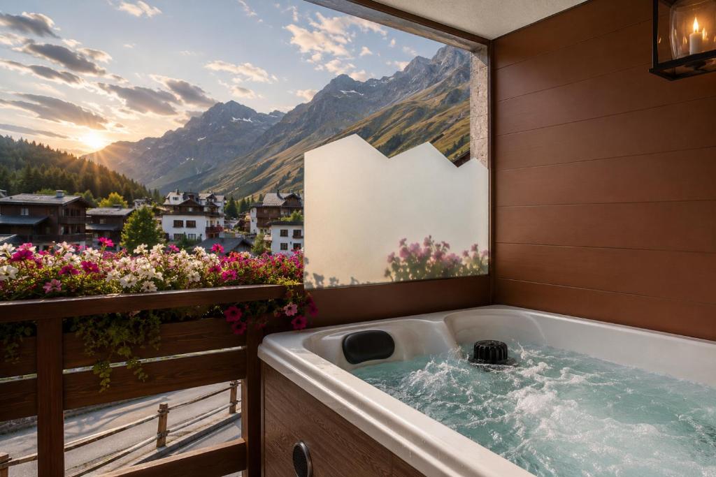 a bath tub with a view of a mountain at Cervinia Ski Apartment François - Private Hot Tub & Mountain View in Breuil-Cervinia