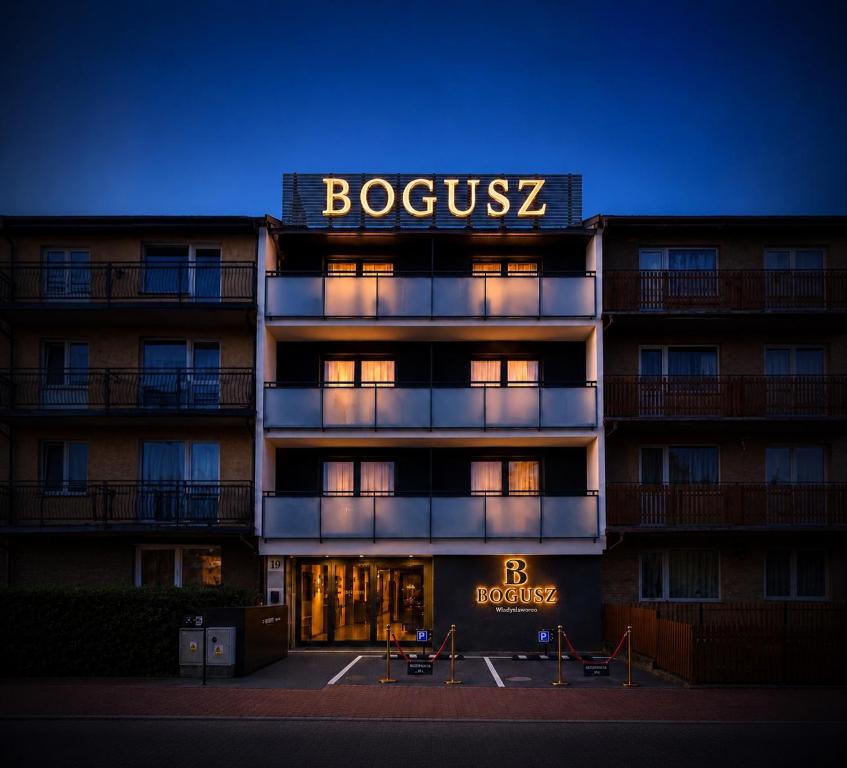 a building with a sign on top of it at The BOGUSZ Wladyslawowo in Władysławowo