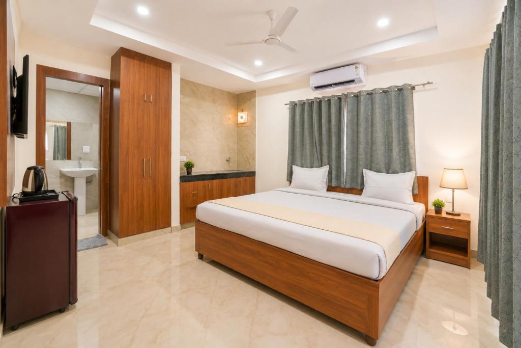 a hotel room with a bed and a bathroom at Hotel Meridian Sector 132, Near Max Hospital in Noida