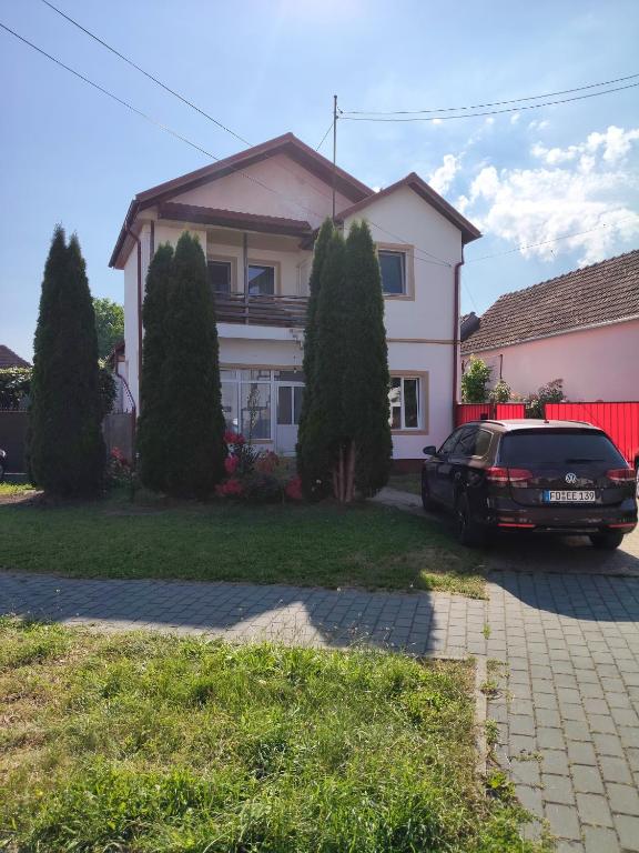 a car parked in front of a house at Green Thuja House in Făgăraş