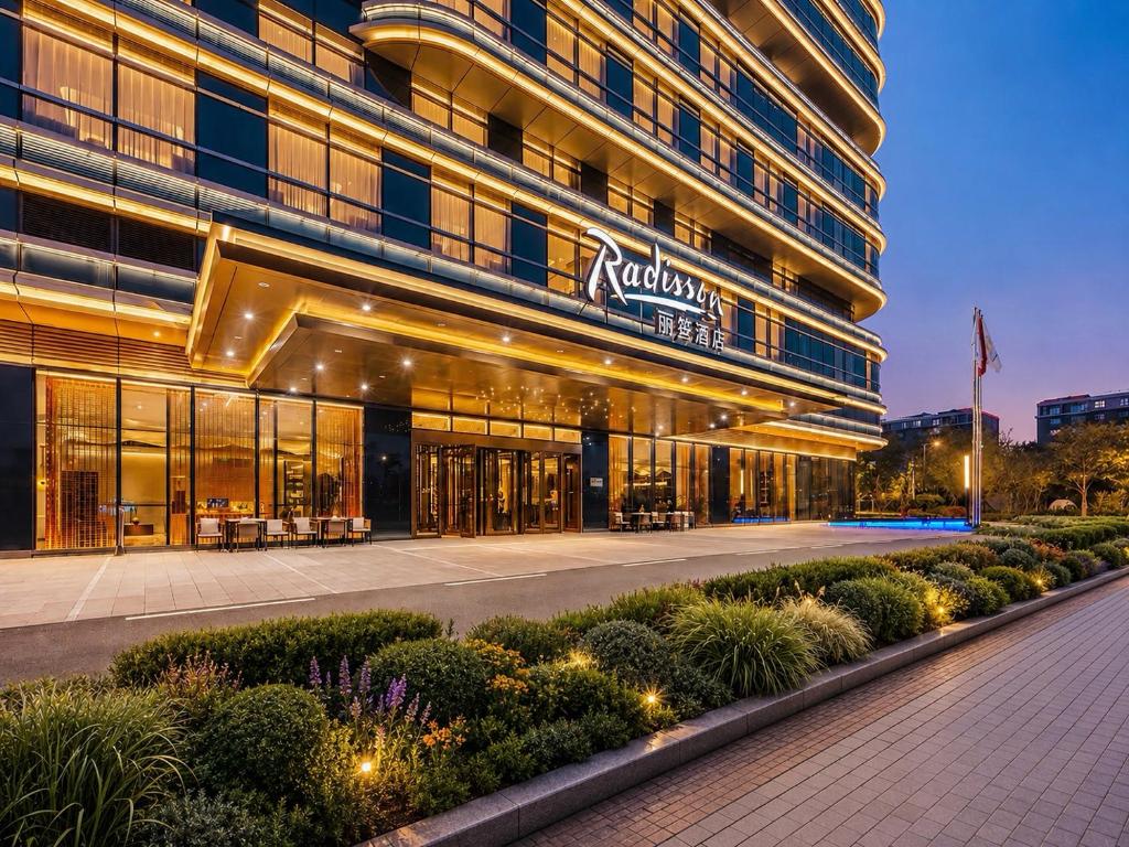 a building with a sign on the side of it at Radisson Hotel, Beijing DaXing Airport in Beijing