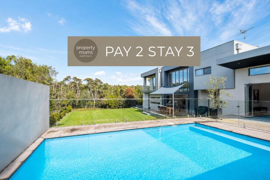 a villa with a swimming pool and a house at Augusta Private Acre Escape in Mount Martha with pool in Mount Martha