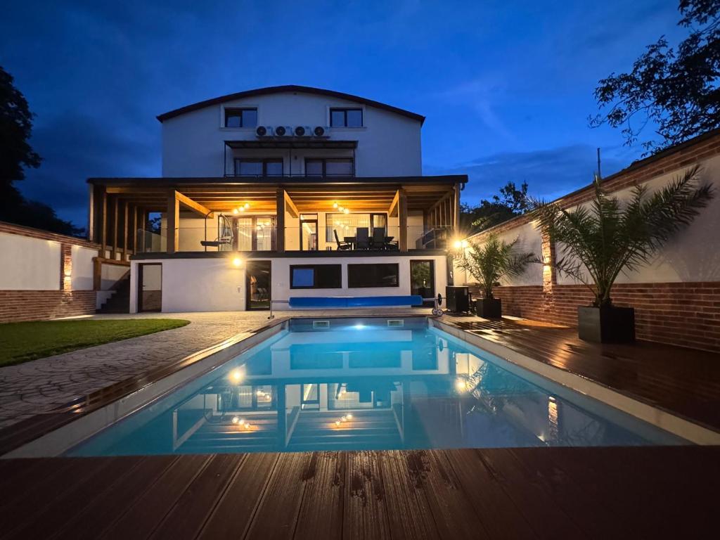 a house with a swimming pool in front of a house at Casa Urbano Mall- Floresti in Floreşti