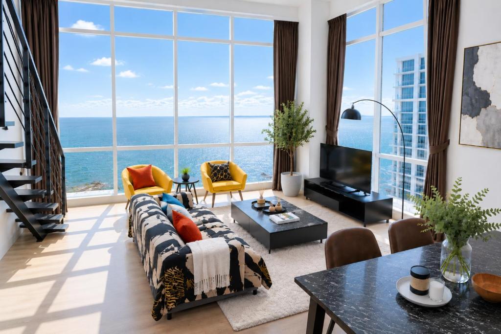 a living room with a view of the ocean at Panoramic Sea view 2BR Duplex High Floor George Town 203A Maritime Suite in George Town