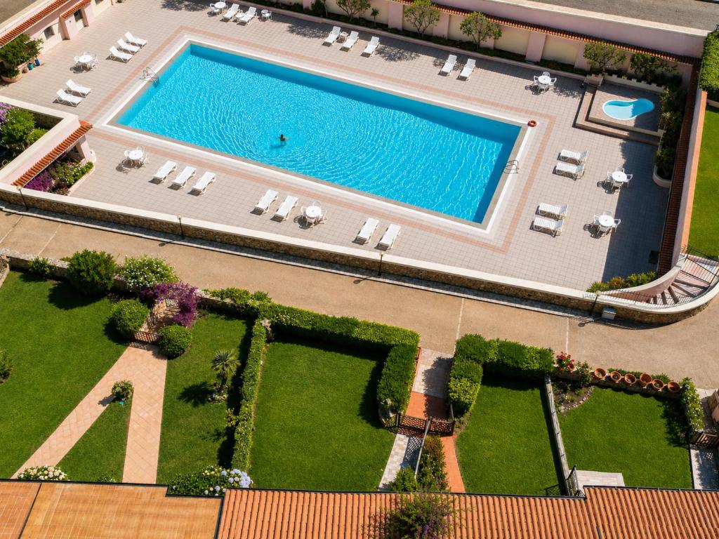 an aerial view of a resort with a swimming pool at Baja Sardinia Sea View And Pool B in Baja Sardinia