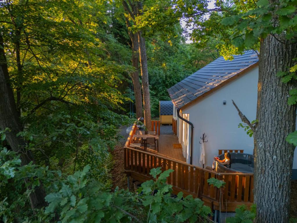 a cabin in the woods with a deck at Fácán Fészek Vendégház in Mátraszentimre