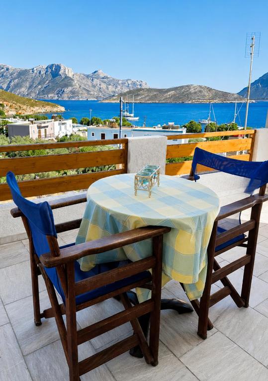 a table and chairs on a balcony with a view of the ocean at Zinovias House in Kalymnos