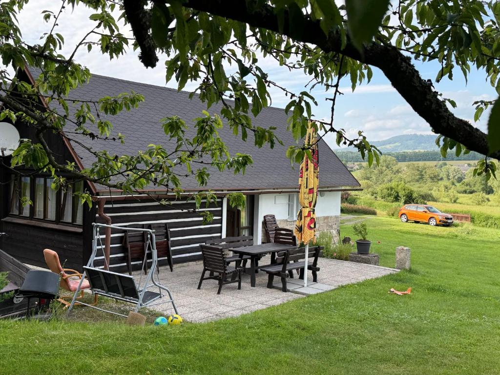 a patio with a table and chairs in front of a house at Ubytování v Jedničce in Hrubá Skála