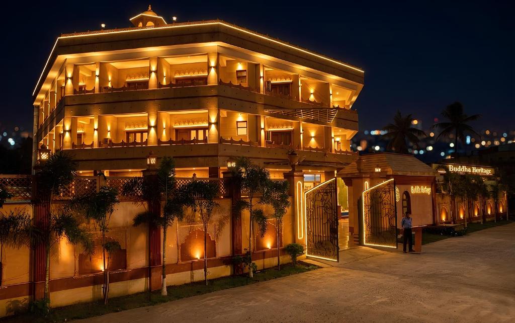 a large building with lights on it at night at Buddha Heritage in Patna