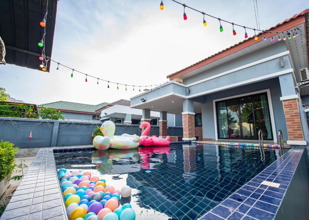 a swimming pool with inflatables and balloons in a house at Richpoolvilla Pattaya in Jomtien Beach