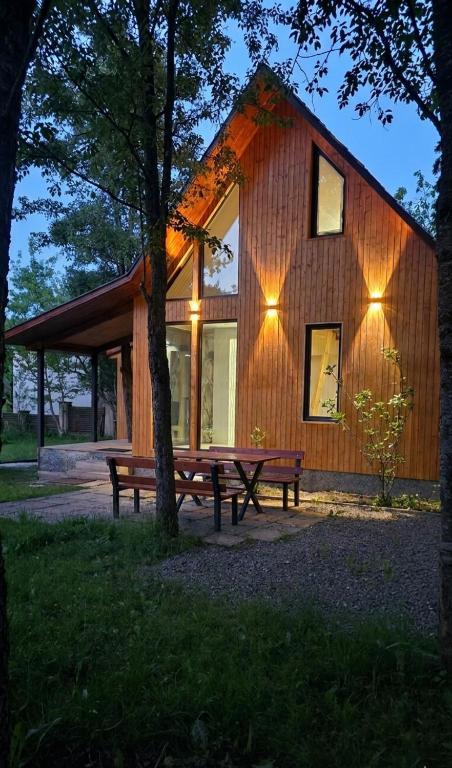 a wooden cabin with a picnic table and a bench at Luxury Cottage Resort in Patara-Tsemi