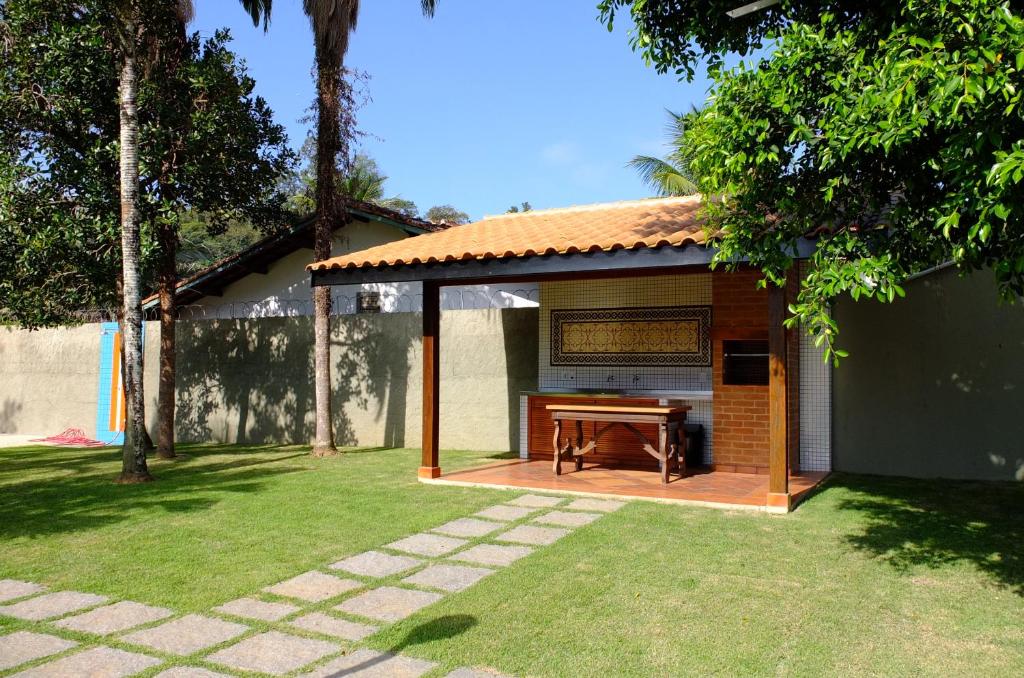 a pavilion with a piano in a yard at Suites Grande Tenorio in Ubatuba