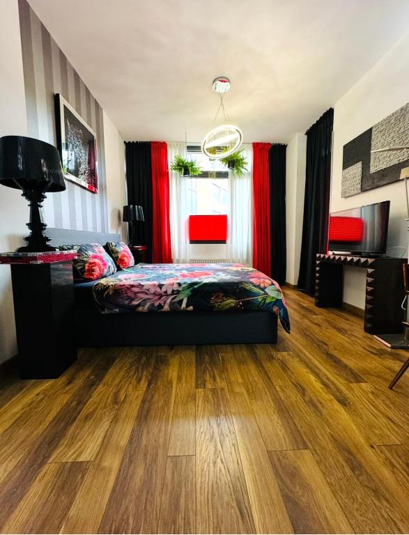 a bedroom with a bed and a wooden floor at High Level Apartment in Mannheim