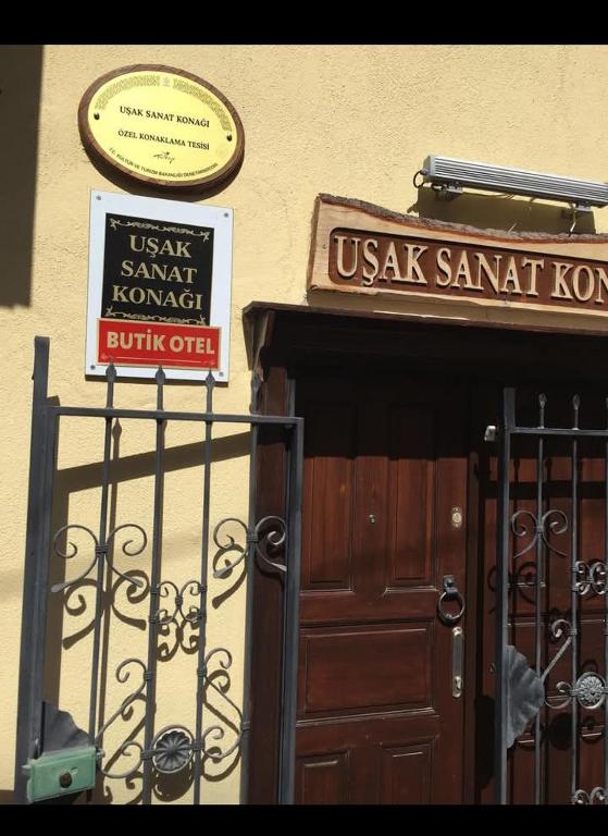 a usax sanatorium sign and a sign above a door at Uşak Sanat Konağı in Uşak