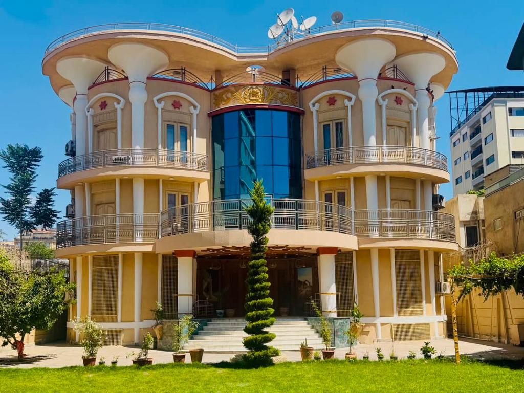 a large yellow building with a round top at Kite Residence - Secure Stay in Kabul