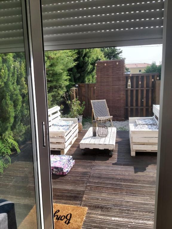 a view of a patio from a sliding glass door at Entire maisonette in Tarn in Busque
