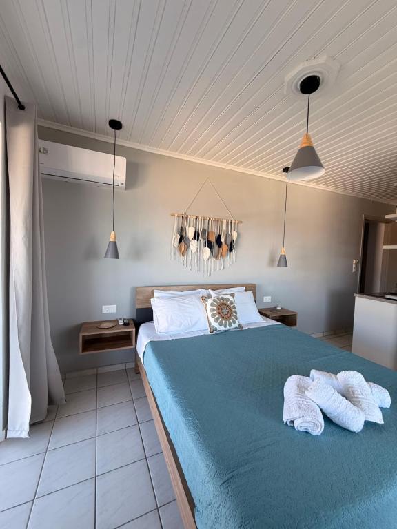 a bedroom with a bed with two towels on it at Vaso Alykanas Studios in Alikanas