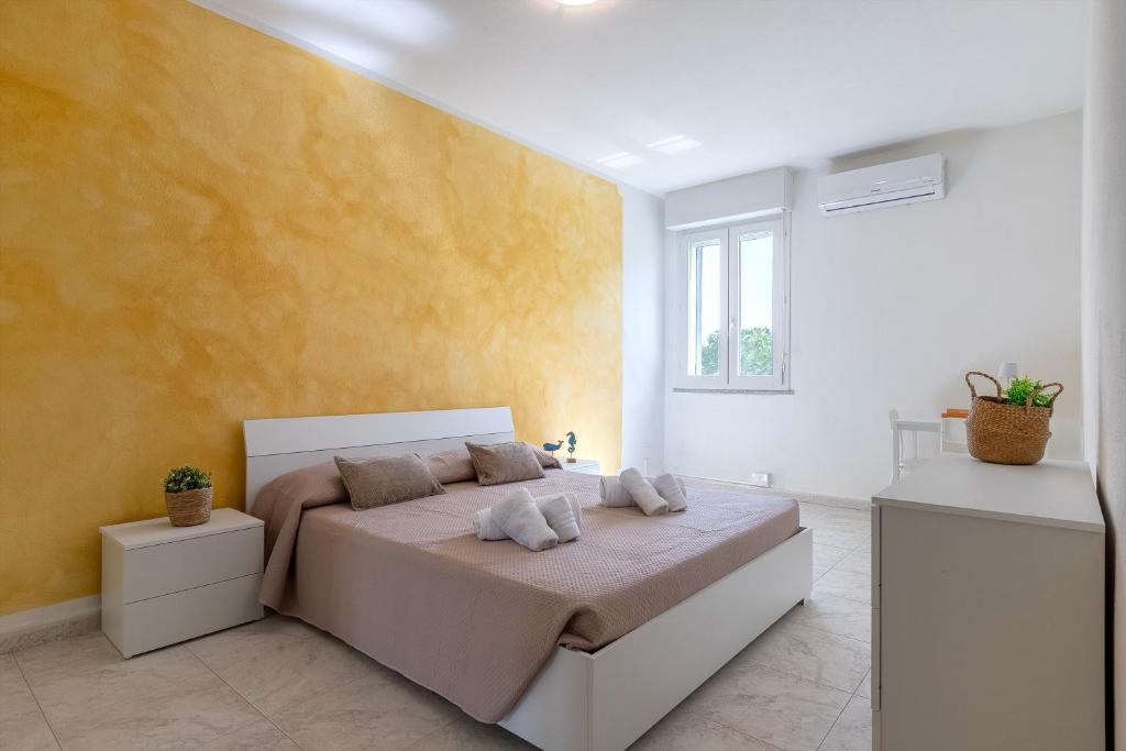 a bedroom with a bed and a yellow wall at Harmony in Nulvi
