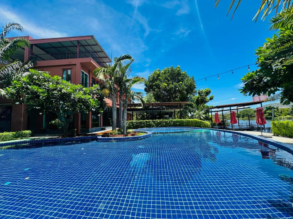 a swimming pool in front of a house at Utime Riverside Kanchanaburi in Ban Yang (2)
