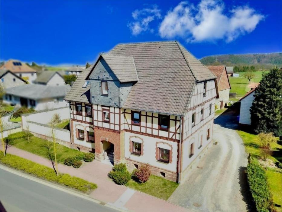 a rendering of a large house on a street at Ferienwohnung Vielfalt in Höringhausen