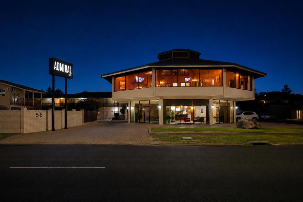 a large building with a sign in front of it at Admiral Motel Bunbury in Bunbury