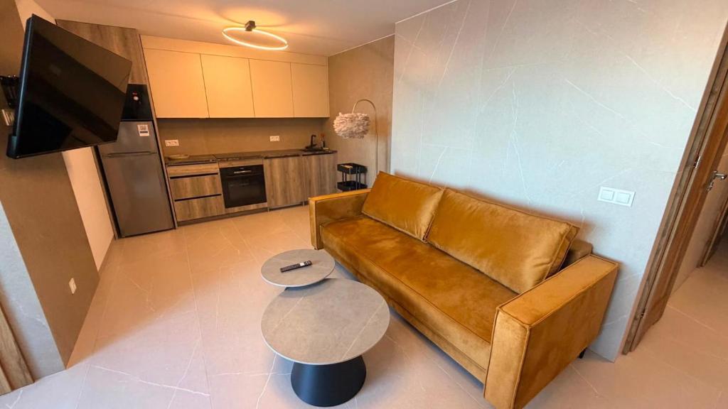 a living room with a couch and a table at La Perla Del Mar APARTAMENT in Torrevieja