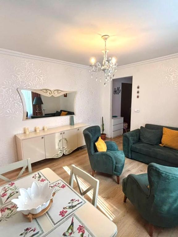 a living room with a couch and a table at Cozy Family Apartment in Tbilisi City