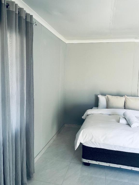 a bedroom with two beds and a window at Koshoka Home in Ompanda