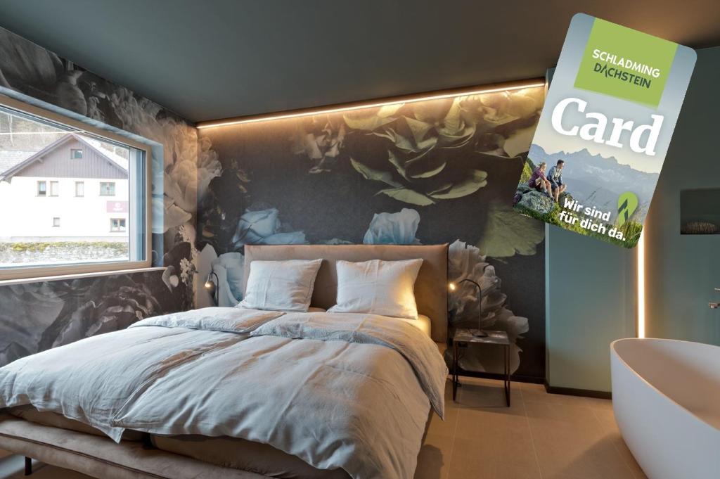 a bedroom with a bed and a wall with a mural at Z-Apartment Parkgasse in Schladming