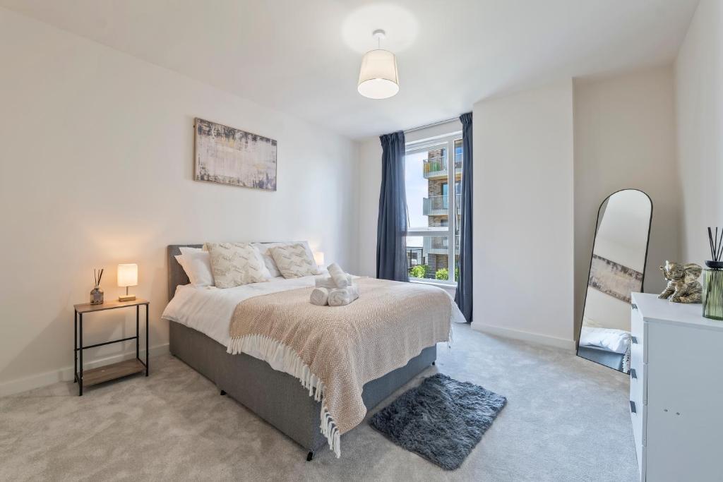 a bedroom with a bed and a large window at Stylish 1-Bed flat with Private Balcony in Hatch End