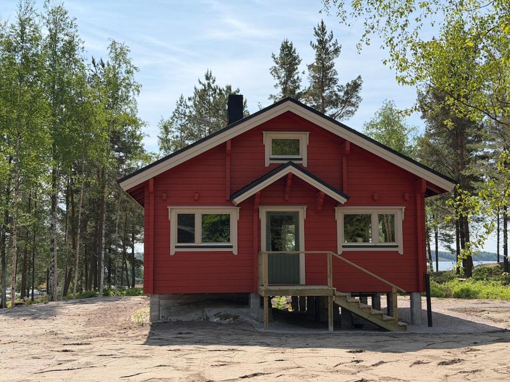 a red house with a porch and a ramp to it at Villa Predium renovated cottage for four in Raseborg