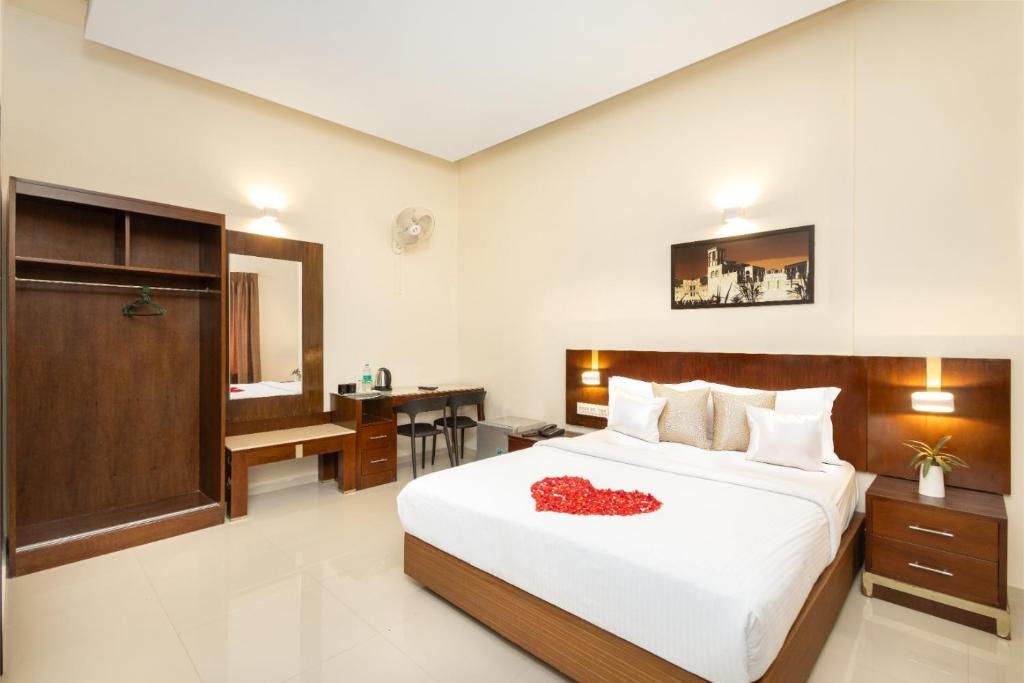 a bedroom with a bed with a red heart on it at The Senate Hotel By Addon Group in Cochin