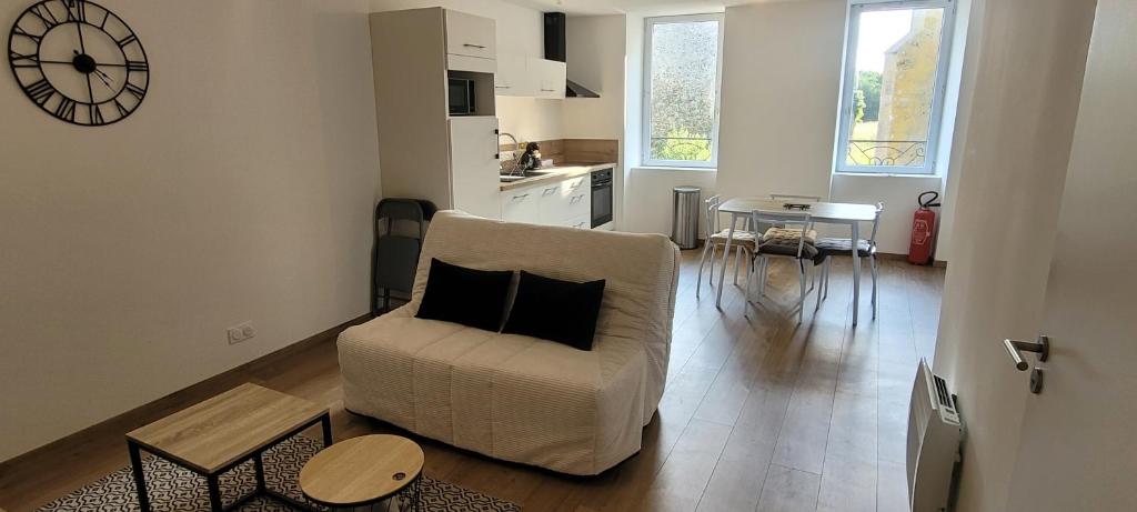 a living room with a couch and a table at Le Logis du Donjon 1 in Les Herbiers