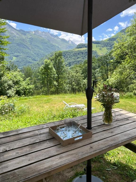a wooden table with a box of glasses on it at Independent and comfortable room in Arrens-Marsous