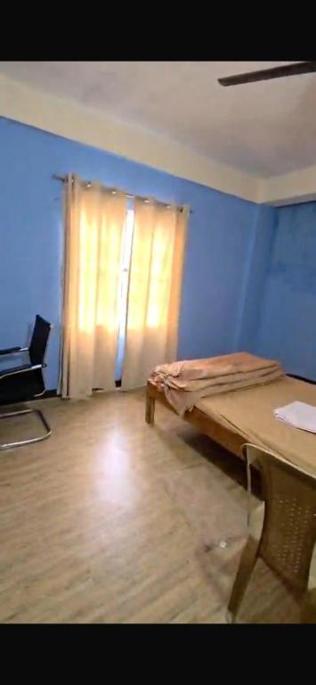 a room with a bed in front of a window at Anigo 3bhk, Itanagar in Itānagar