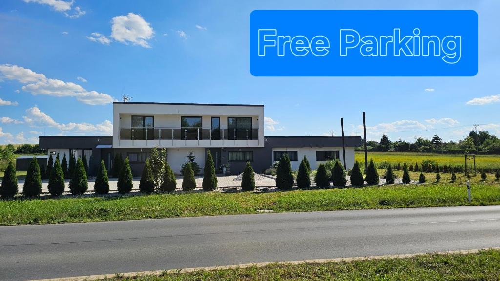 a building on the side of a road with the words free parking at APARTMÁNY I&V - Adults Only in Pilsen