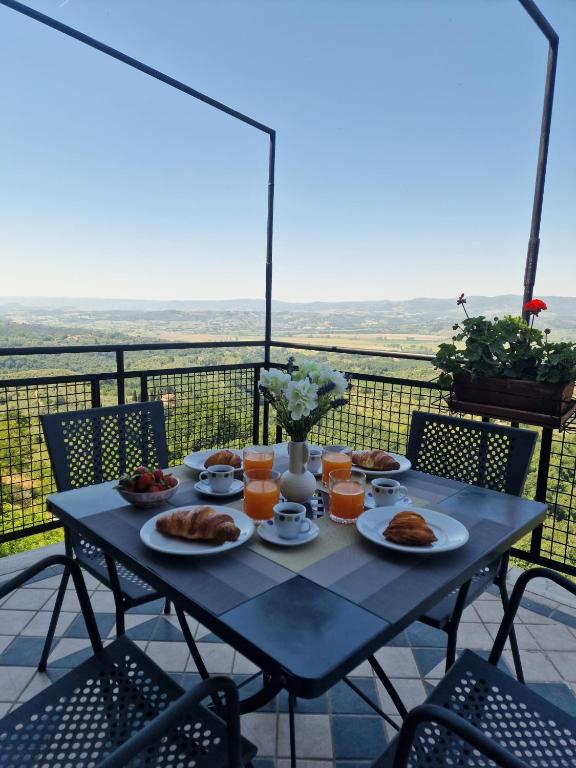 a table with plates of food on a balcony at Casa Ferdinanda in Monteleone dʼOrvieto