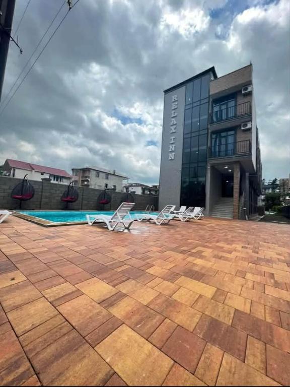 a group of chairs sitting in front of a building at Relax inn in Kobuleti