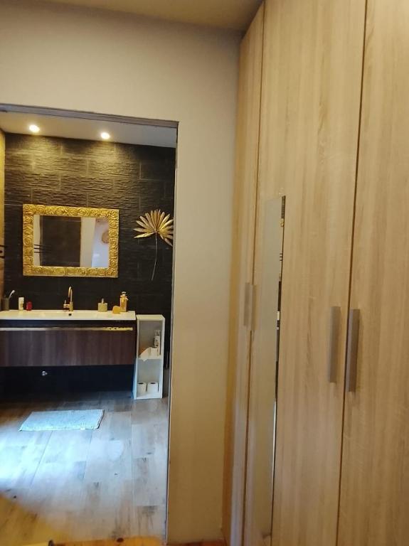 a bathroom with a sink and a mirror at Telhadosolitario in São Pedro da Cova